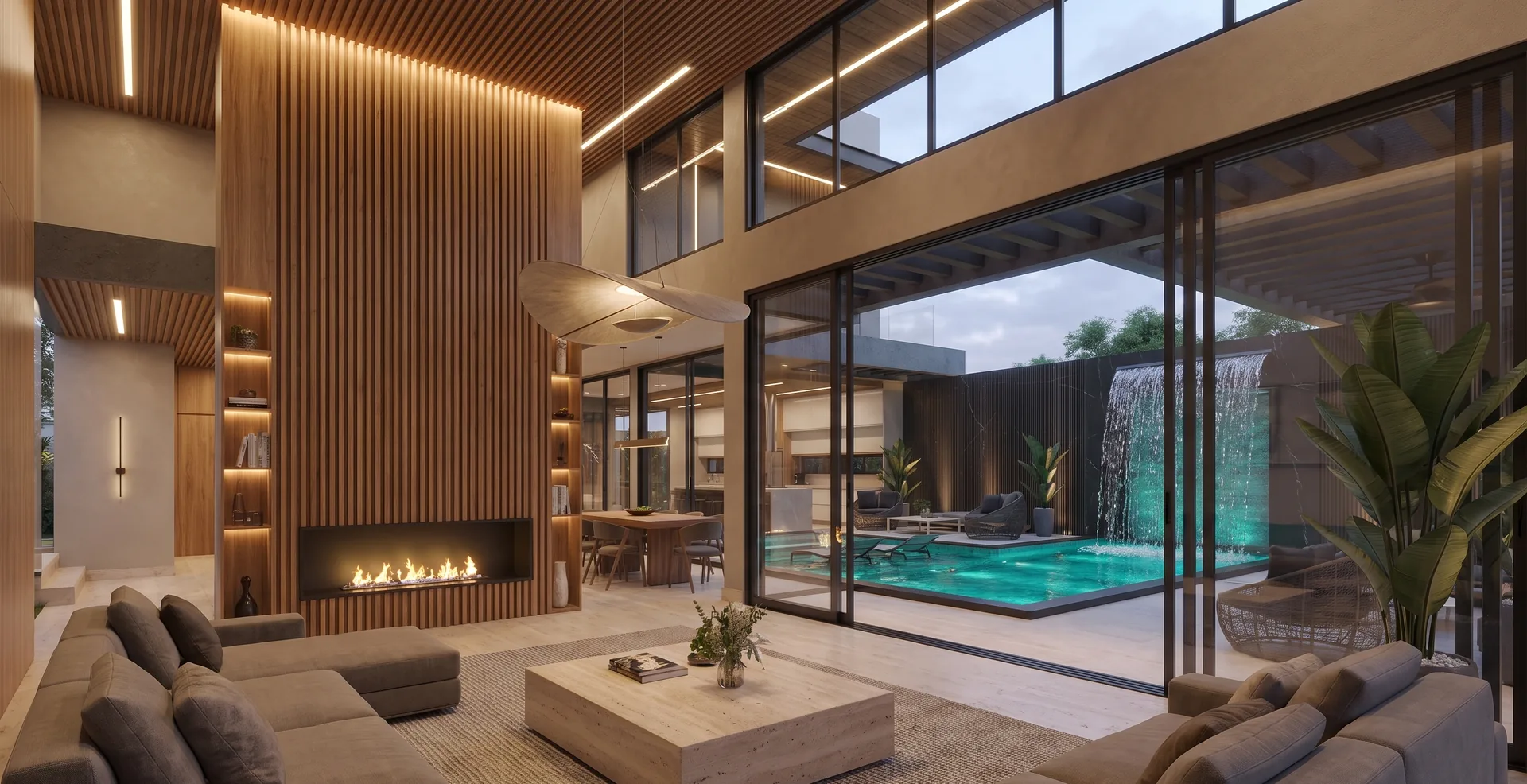 Double-height living room with an oak slat fireplace wall, pendant light and full-height glass onto the pool and waterfall